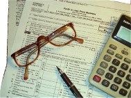 photo of glasses, calculator and tax return